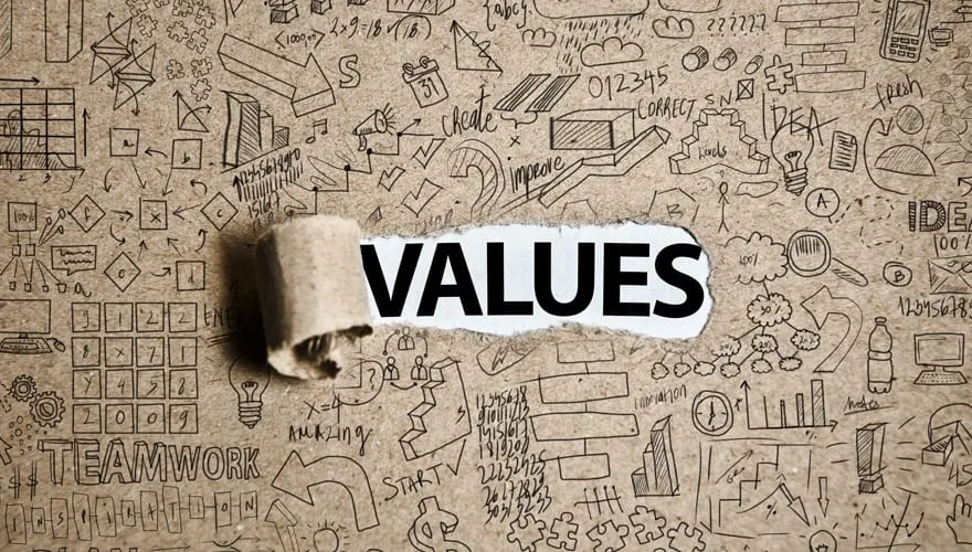 The word VALUES revealed on white paper through torn cardboard, surrounded by hand-drawn business doodles and icons