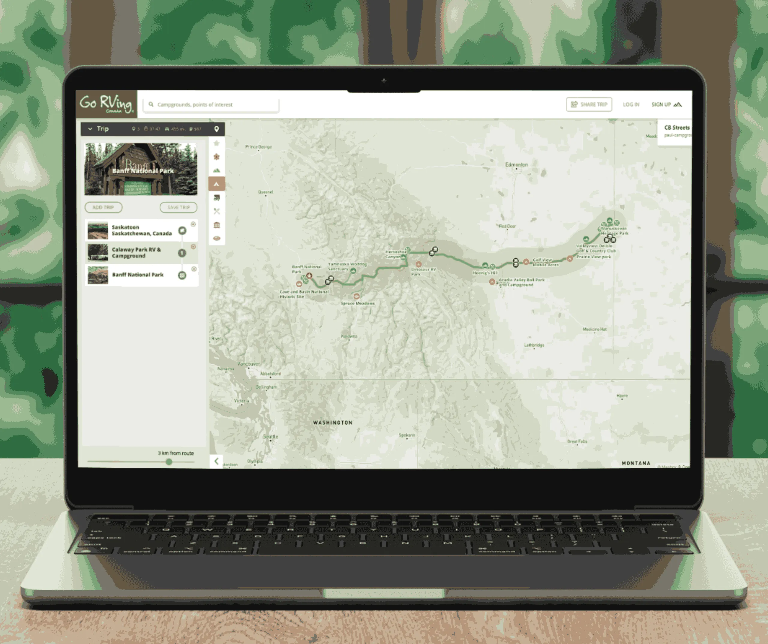 Laptop showing Go RVing trip-planner screen with a route mapped across western US and Canada and a saved-stops sidebar