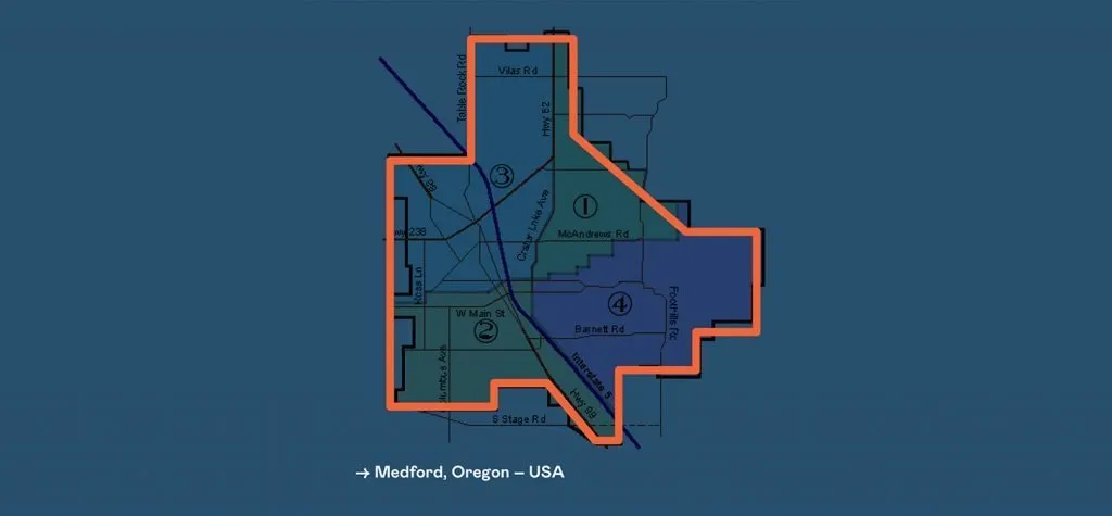 Annotated map of Medford, Oregon with the city-limits boundary outlined in orange on a blue background