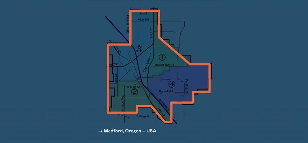 Annotated map of Medford, Oregon with the city-limits boundary outlined in orange on a blue background