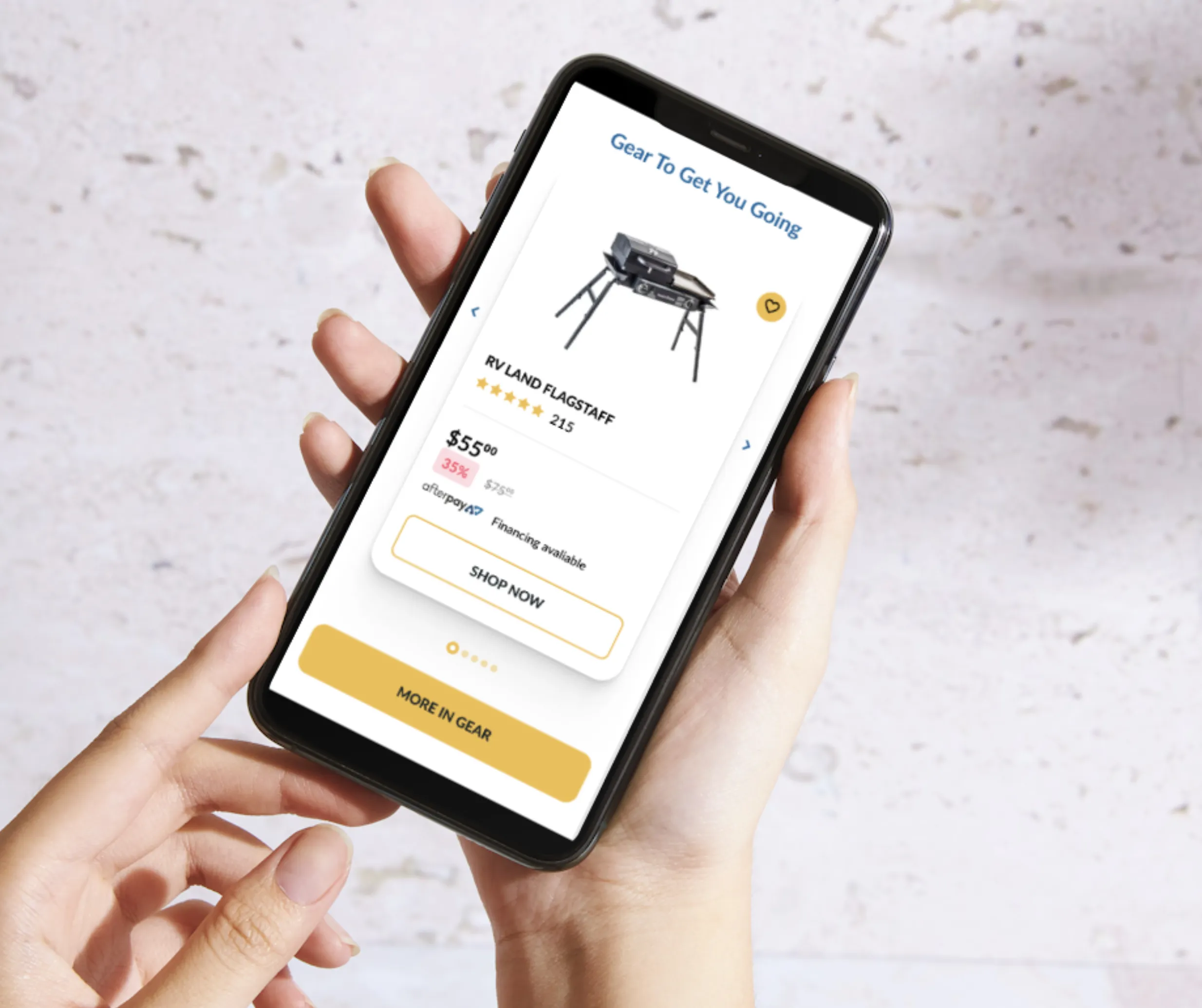 Hands holding a phone showing a Camping World product page for an RV Land Flagstaff item with rating, price and Shop Now button
