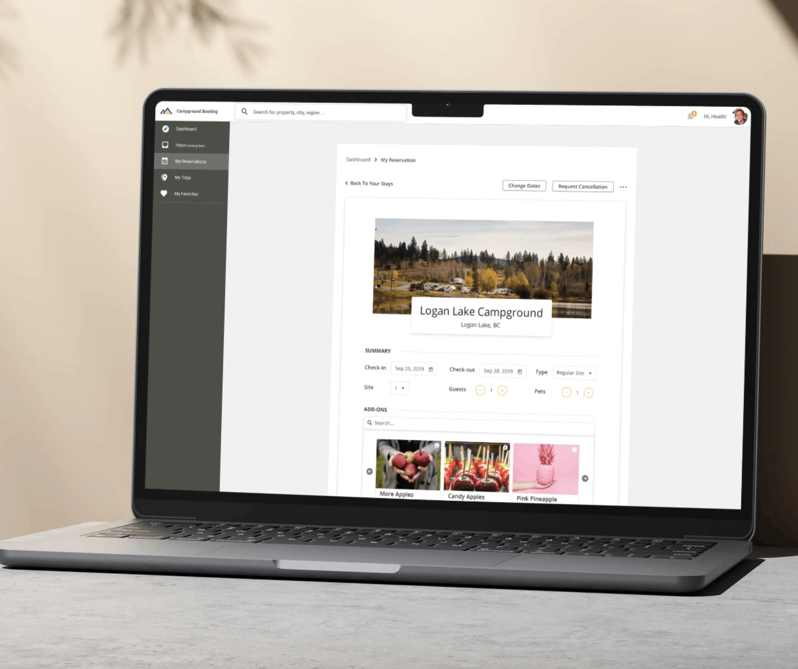 Laptop showing My Reservations screen for Logan Lake Campground with dates, guest details and add-on product thumbnails