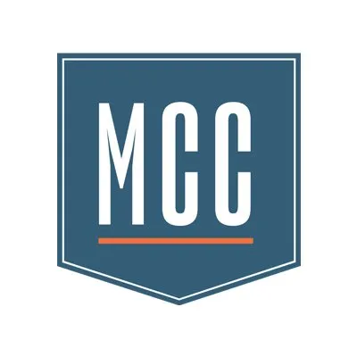 MCC monogram concept — bold 'MCC' in a blue shield badge with an orange underline
